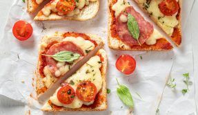 Crunchy,Toast,With,Cheese,,Salami,And,Basil,On,White,Paper